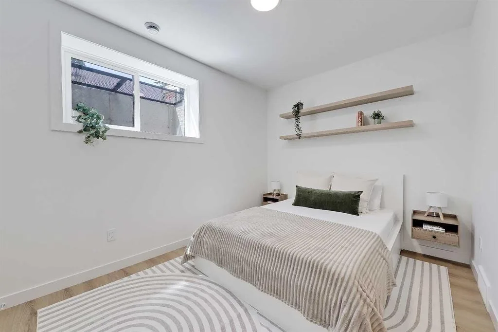 Primary bedroom with floating wood shelves above the bed