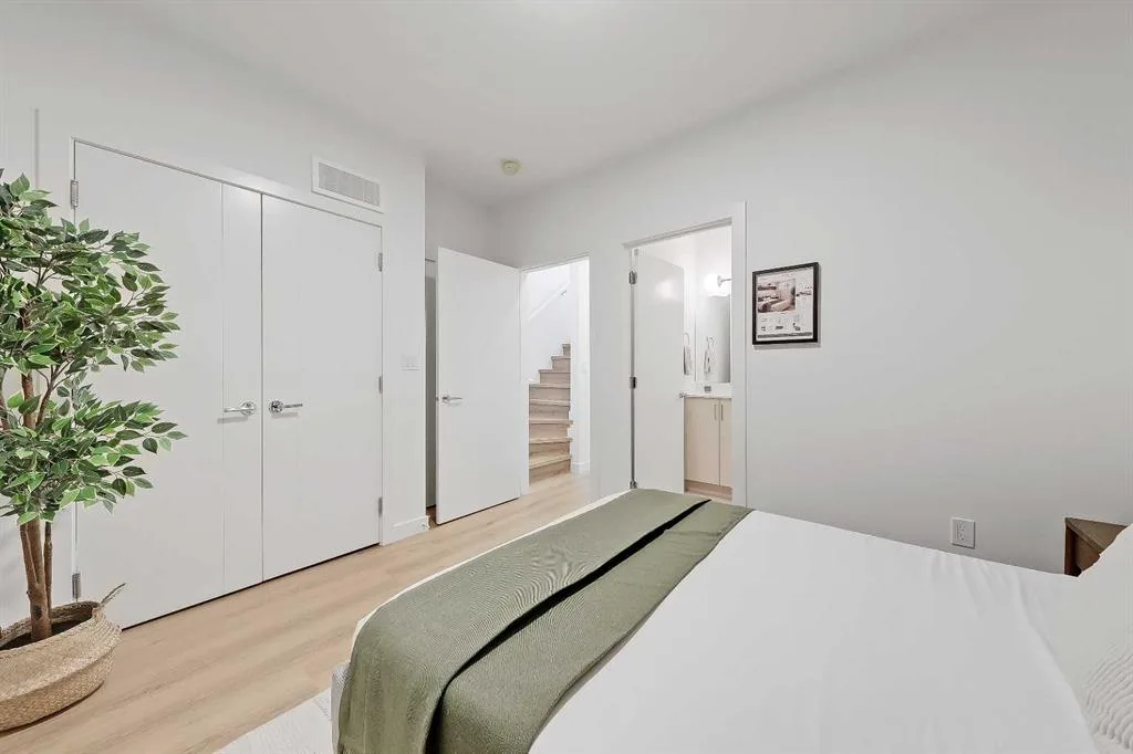 Second bedroom foreground showing staircase and ensuite view