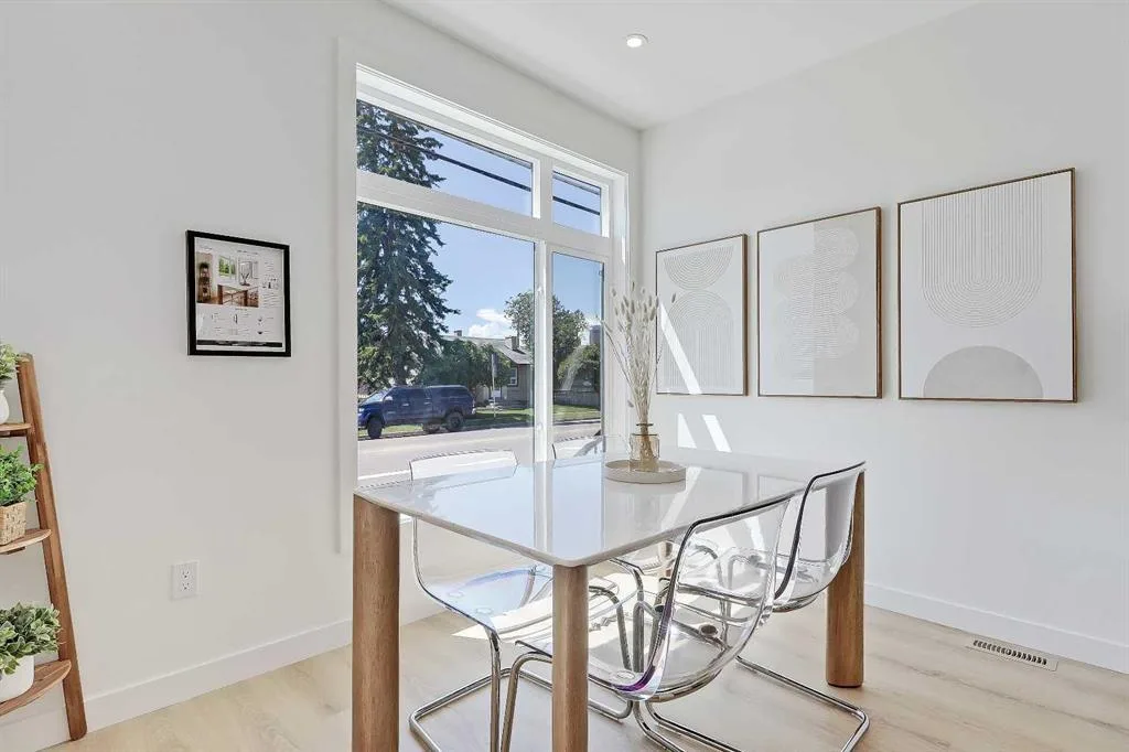 Dining nook with street-facing window and framed art gallery wall
