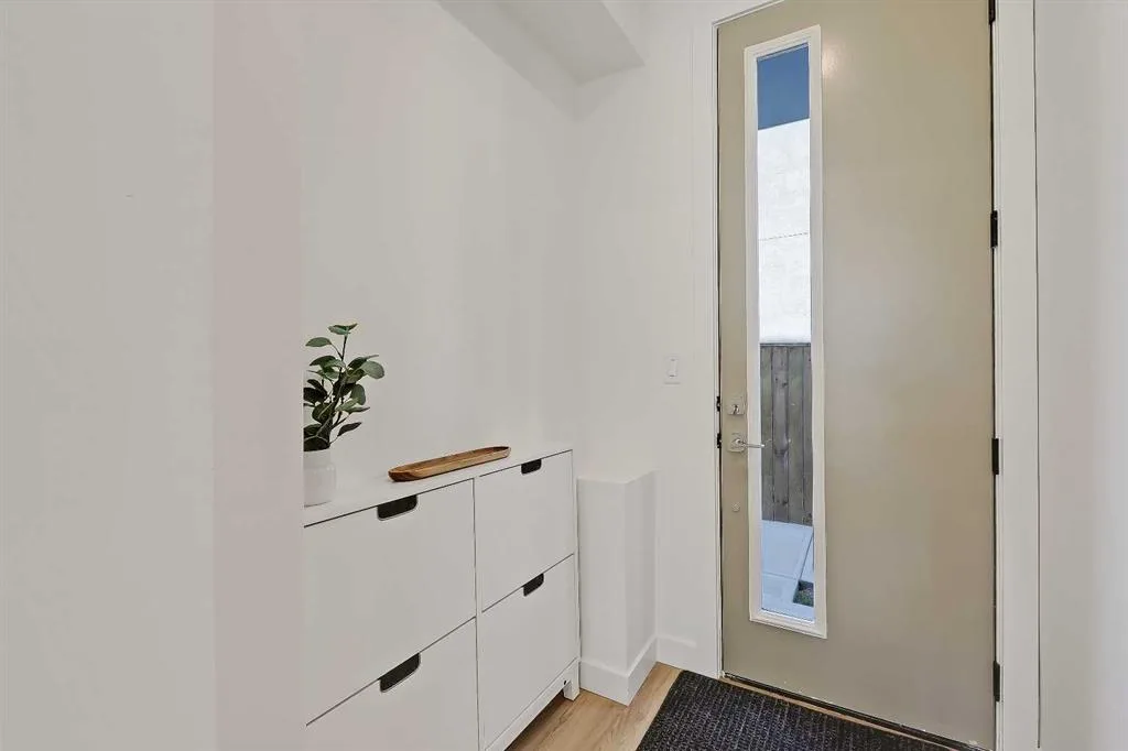 Front entry hallway with console table and glass-panel door