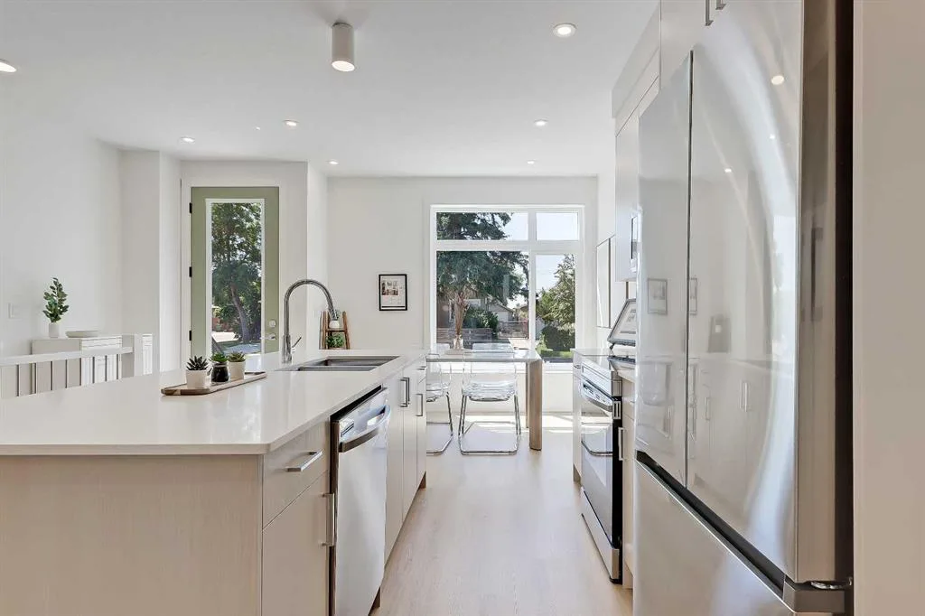 Kitchen and dining area with glass door leading to the backyard