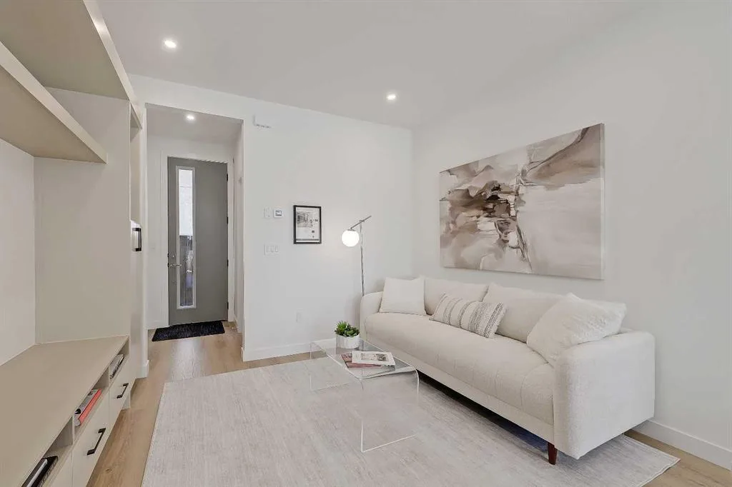 Living room with built-in media wall and view to the front door