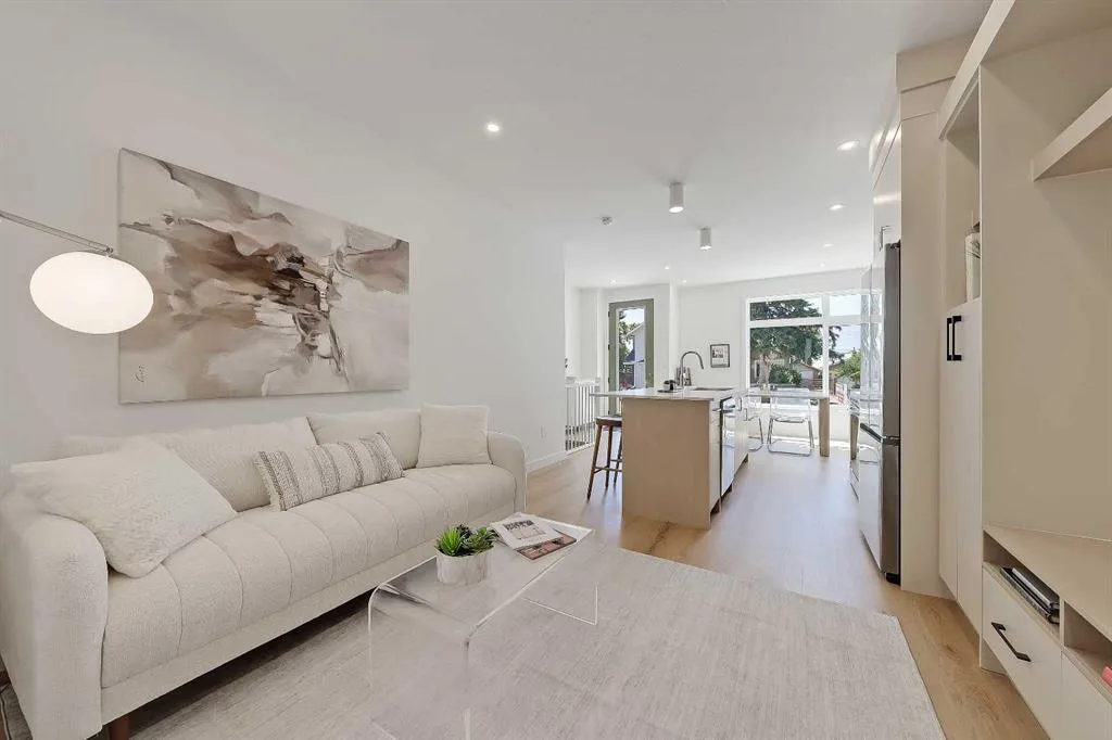 Living room with cream sofa looking toward the kitchen island