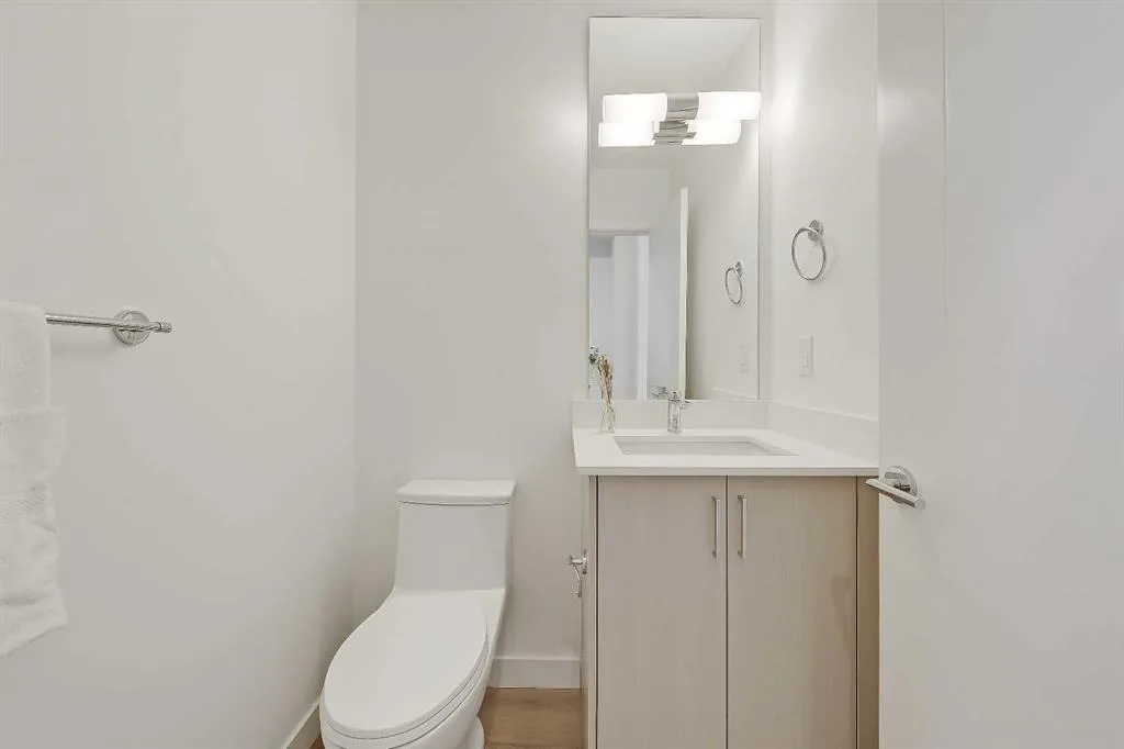 Main floor powder room with floating vanity and mirror